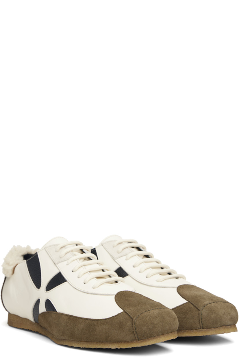 Low-top suede and buffed leather sneakers.

· Square toe
· Lace-up closure
· Shearling trim at padded heel collar
· Graphic cutouts at sides
· Buffed leather lining
· Crêpe-rubber sole

Supplier color: White/White