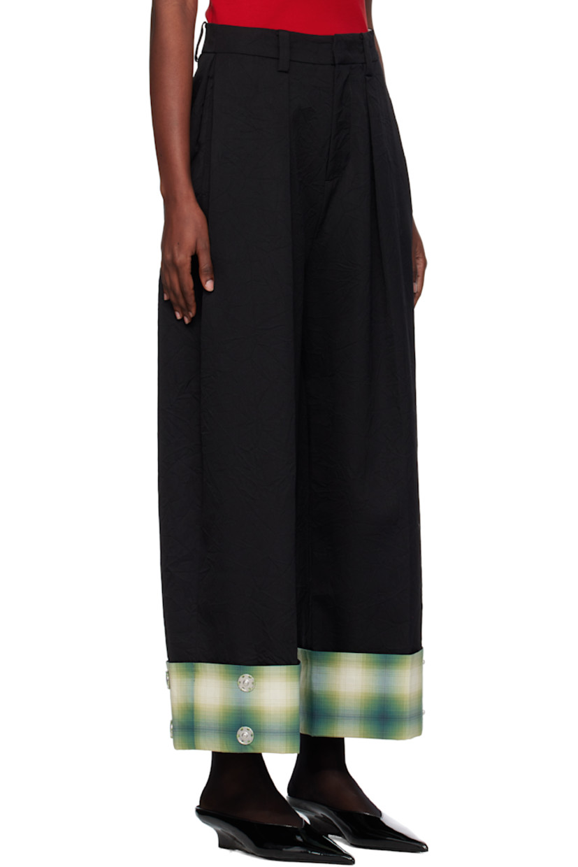 Crinkled wool twill trousers.

· Belt loops
· Two-pocket styling
· Zip fly
· Pleats at front
· Creased legs
· Press-stud fastenings and check pattern at rolled cuffs

Supplier color: Black