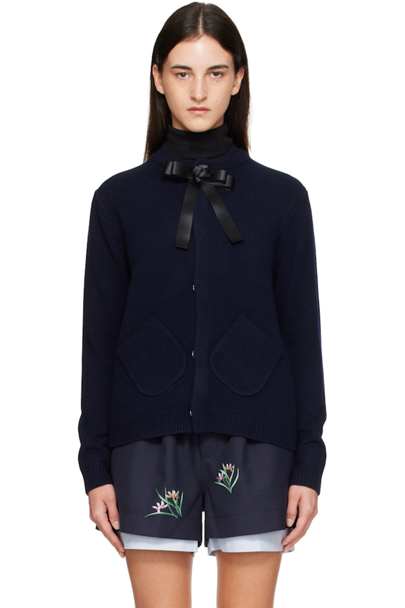 Brushed knit wool cardigan.

· Layered rib-knit round neck
· Concealed press-stud closure
· Detachable satin bow at top button
· Patch pockets at waist
· Rib-knit hem and cuffs
· Embroidered logo at back collar

Supplier color: Navy