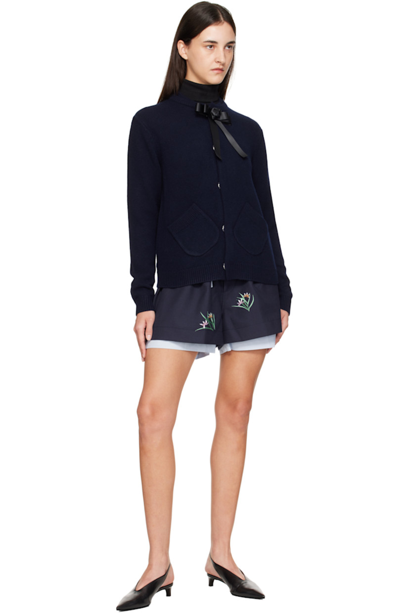 Brushed knit wool cardigan.

· Layered rib-knit round neck
· Concealed press-stud closure
· Detachable satin bow at top button
· Patch pockets at waist
· Rib-knit hem and cuffs
· Embroidered logo at back collar

Supplier color: Navy