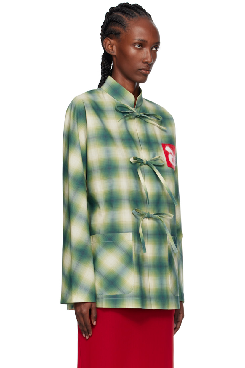 Cotton poplin shirt.

· Check pattern throughout
· Stand collar
· Self-tie closure with press-stud placket
· Logo patch at chest
· Patch pockets at front

Supplier color: Check