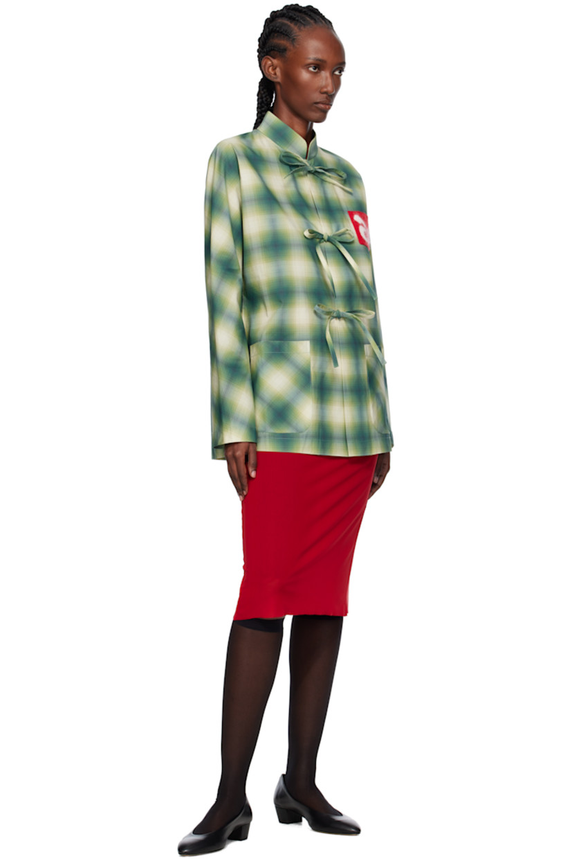 Cotton poplin shirt.

· Check pattern throughout
· Stand collar
· Self-tie closure with press-stud placket
· Logo patch at chest
· Patch pockets at front

Supplier color: Check