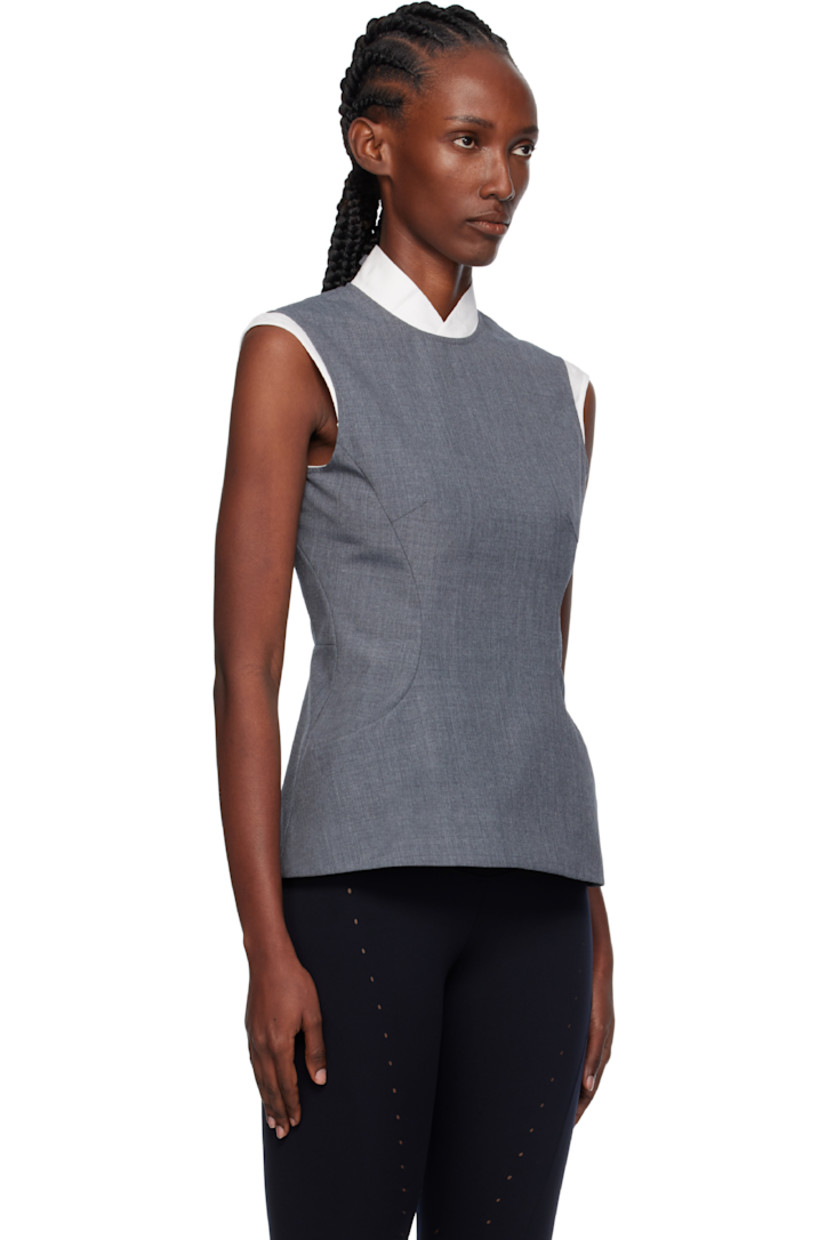 Wool twill top.

· Stand collar
· Princess seams at front
· Padded hips
· Self-tie fastening and zip closure at back

Supplier color: Grey