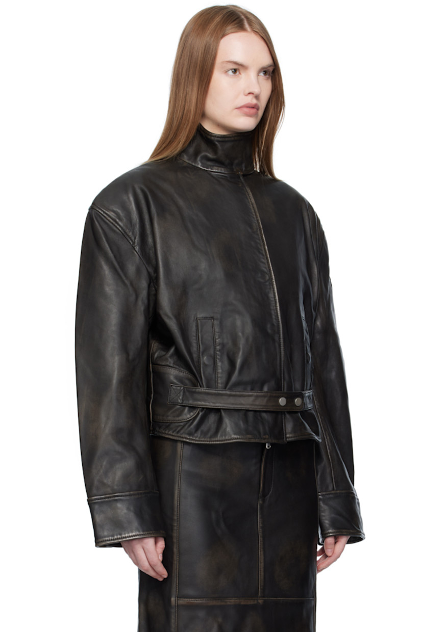 Grained lambskin jacket. 

· Smudging throughout 
· Press-stud closure at stand collar 
· Concealed two-way zip closure 
· Press-stud placket 
· Welt pockets and integrated press-stud straps at waist 
· Press-stud barrel cuffs
· Welt pocket at interior 
· Full cupro satin twill lining

Supplier color: Black