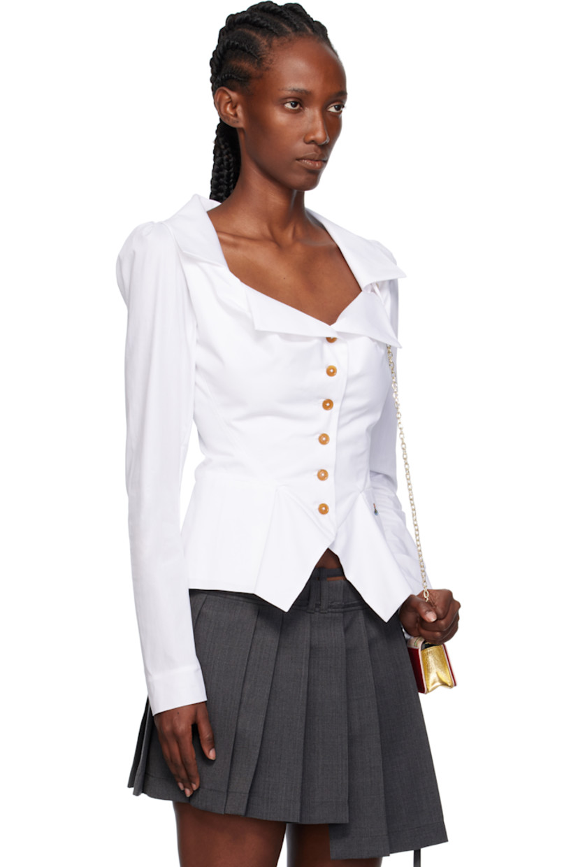 Lightweight regenerative cotton poplin shirt.

· Notched lapel
· Button closure
· Darts at front
· Welt pockets
· Embroidered logo at front hem
· Peplum hem
· Puff sleeves

Supplier color: White