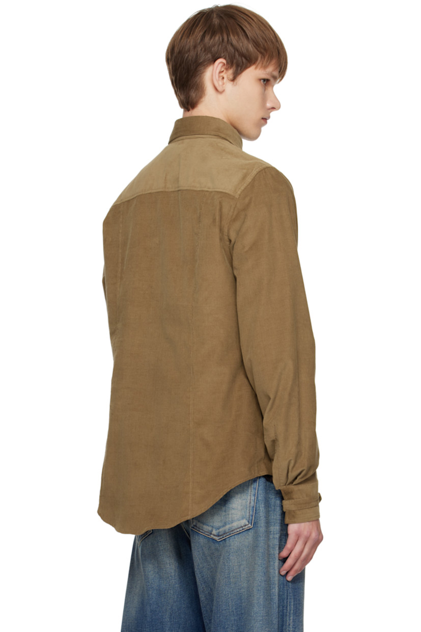 Organic cotton corduroy shirt.

· Cinch strap at spread collar and cuffs
· Button closure
· Logo embroidered at chest
· Flap pockets and zip pocket at chest
· Shirttail hem
· Press-stud barrel cuffs

Supplier color: Tobacco