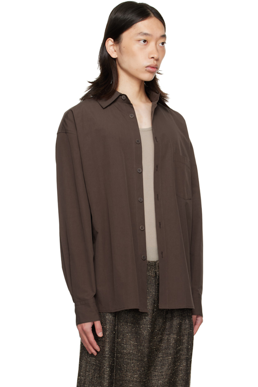 Cotton poplin shirt.

· Spread collar
· Button closure
· Patch pocket at chest
· Shirttail hem
· Buttoned barrel cuffs
· Pleats at back yoke
· Corozo hardware

Supplier color: Dark mauve