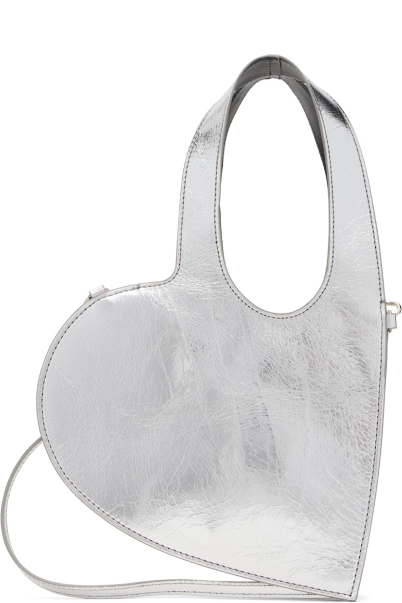 Heart-shaped crinkled patent leather shoulder bag.

· Twin carry handles
· Detachable and adjustable crossbody strap
· Logo stamp at face
· Buffed leather lining
· H6.25" x W8"
· Total height: H12"

Supplier color: Silver