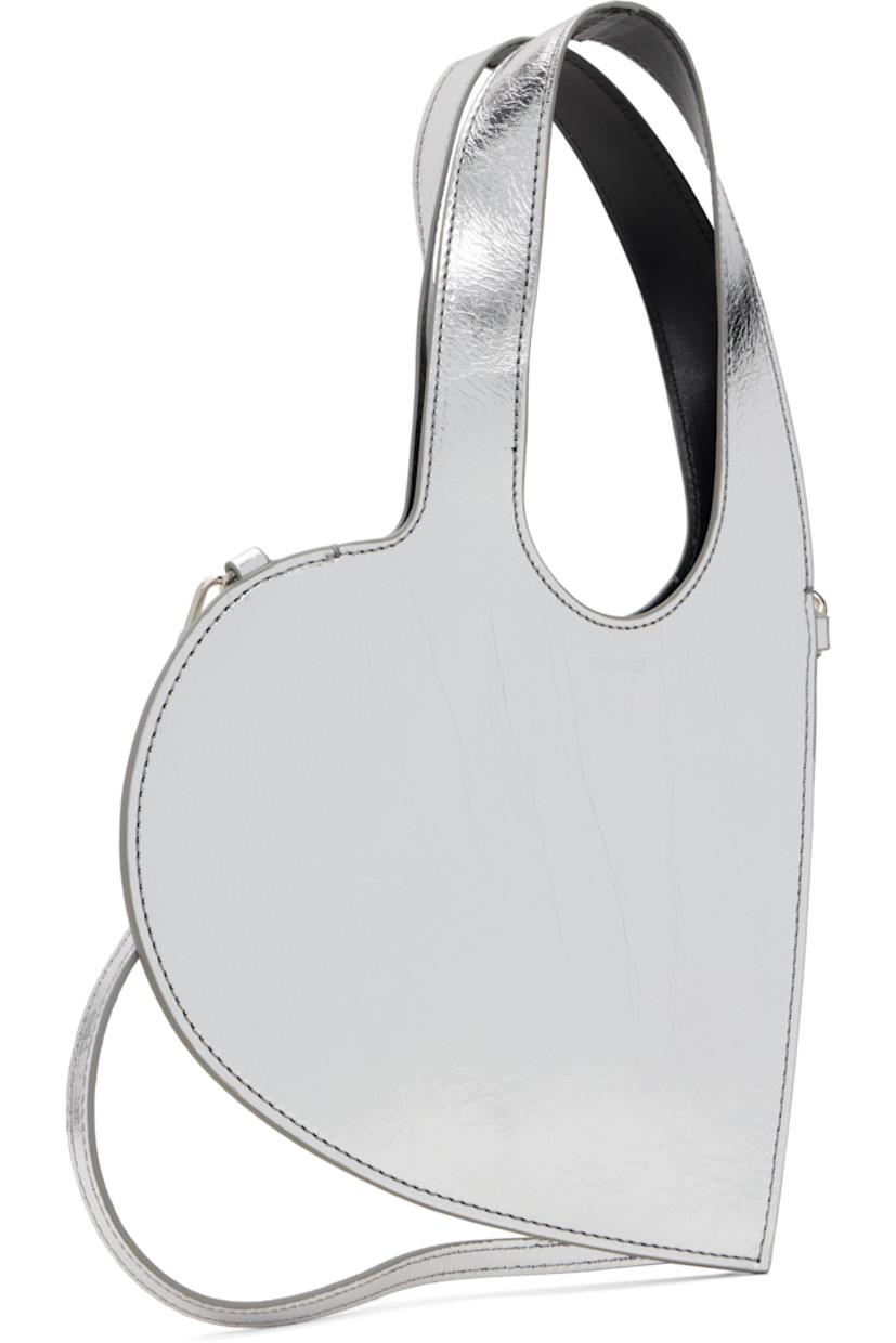 Heart-shaped crinkled patent leather shoulder bag.

· Twin carry handles
· Detachable and adjustable crossbody strap
· Logo stamp at face
· Buffed leather lining
· H6.25" x W8"
· Total height: H12"

Supplier color: Silver