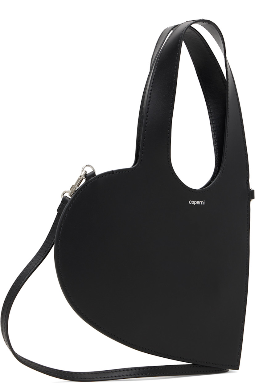 Heart-shaped buffed leather shoulder bag.

· Twin carry handles
· Detachable and adjustable crossbody strap
· Logo stamp at face
· Buffed leather lining
· H6.25" x W8"
· Total height: H12"

Supplier color: Black