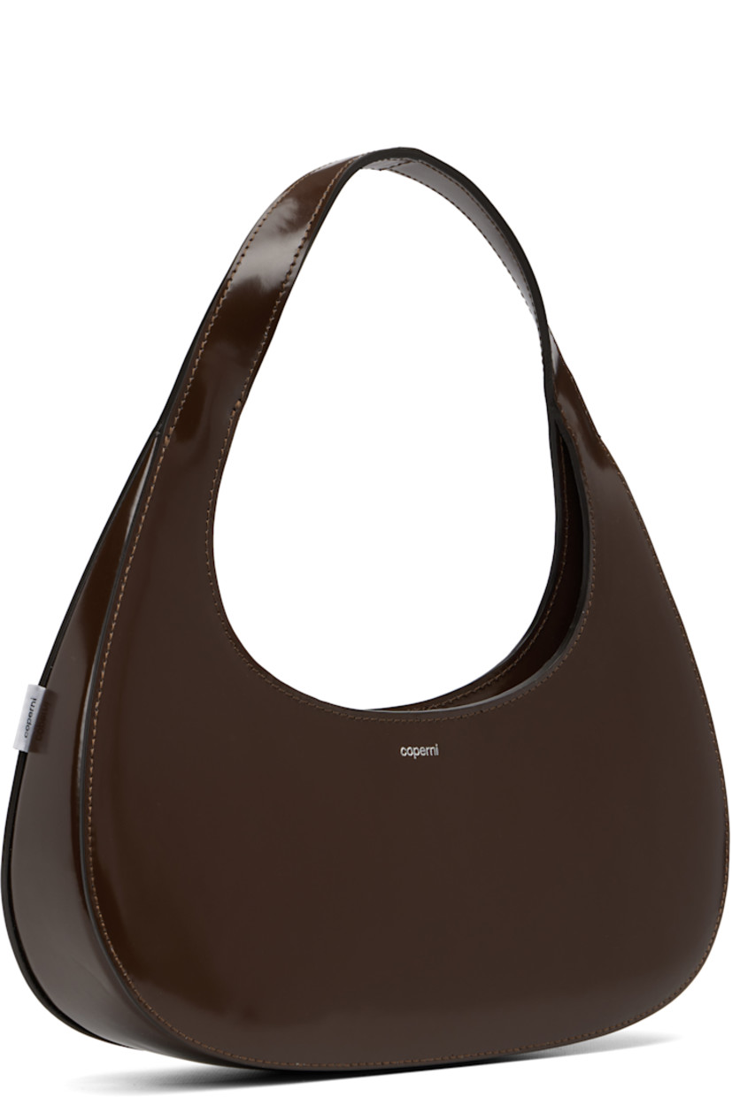 Polished leather shoulder bag.

· Integrated shoulder strap
· Logo stamp at face
· Logo flag at side
· Two-way zip closure
· Suede interior
· H4.5" x W11" x D2.25"

Supplier color: Brown