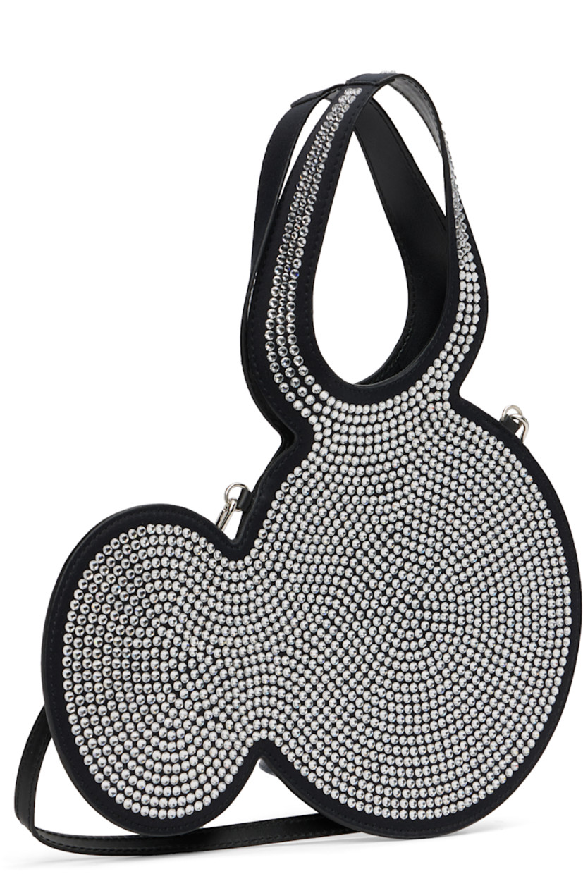 Graphic satin tote.

· Integrated carry handle 
· Adjustable and detachable leather crossbody strap
· Crystal-cut accents at face 
· Open throat
· H7.5" x W11" 
· Total height: H11.5"

Part of the Disney capsule.

Supplier color: Black/Silver