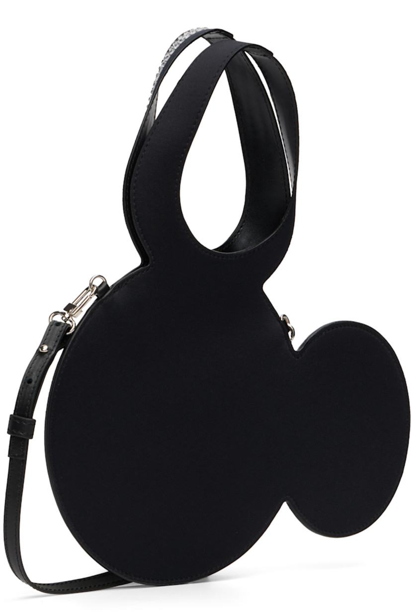 Graphic satin tote.

· Integrated carry handle 
· Adjustable and detachable leather crossbody strap
· Crystal-cut accents at face 
· Open throat
· H7.5" x W11" 
· Total height: H11.5"

Part of the Disney capsule.

Supplier color: Black/Silver