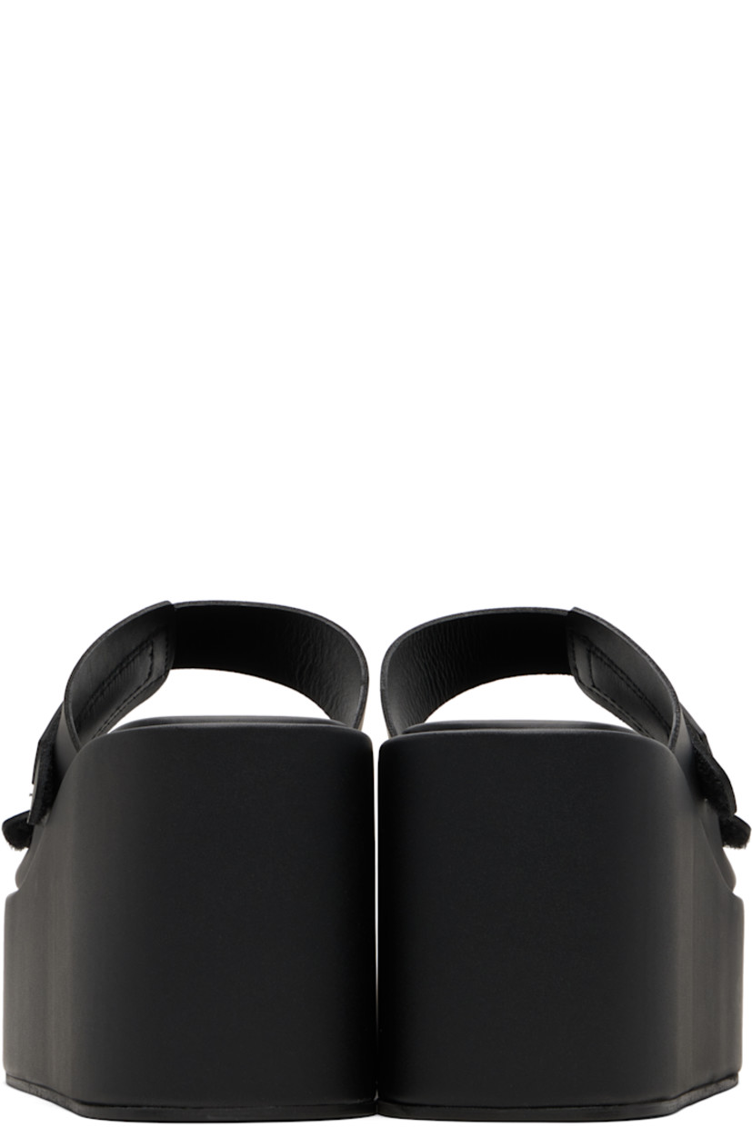 Buffed faux-leather slip-on heeled sandals.

· Open toe
· Velcro strap at vamp
· Rubberized logo patch at fixed strap
· Covered lightweight rubber platform midsole
· Rubber sole
· Platform: H2"
· Heel: H3.75"

Supplier color: Black