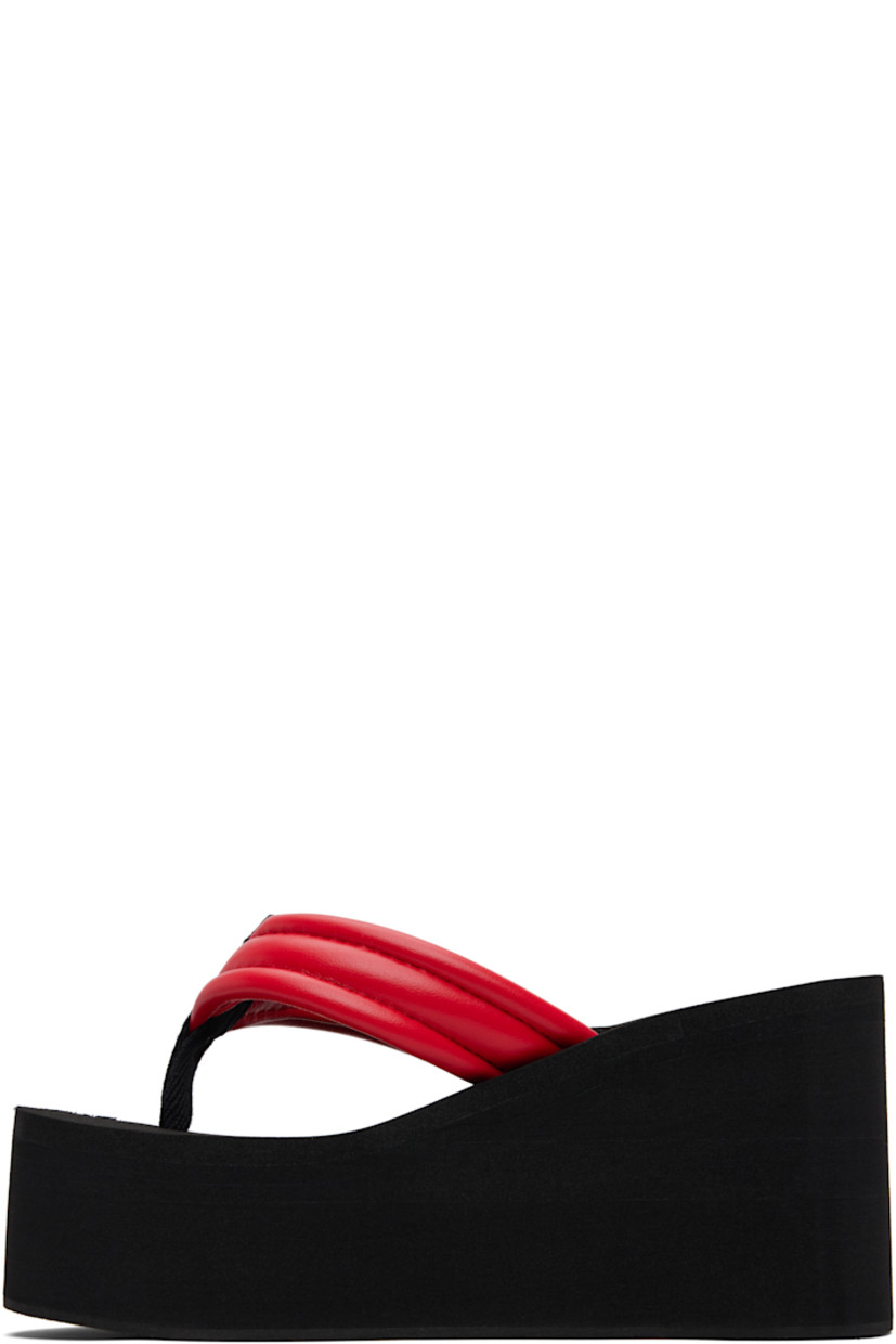 Buffed faux-leather heeled sandals.

· Thong-style strap and logo patch at vamp
· Foam rubber platform midsole
· Crêpe rubber sole
· Platform: H2"
· Heel: H3.75"

Supplier color: Black/Red