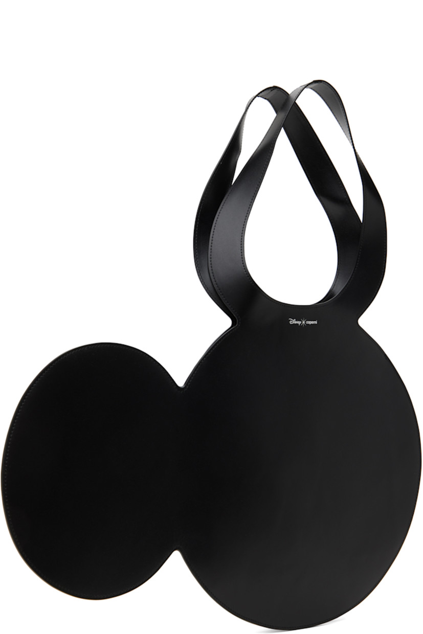 Graphic buffed calfskin tote in black.

· Twin carry handles
· Silver-tone logo stamp at face 
· Open throat
· H13.5" x W19.75"
· Total height: H21"

Part of the Disney capsule.

Supplier color: Black