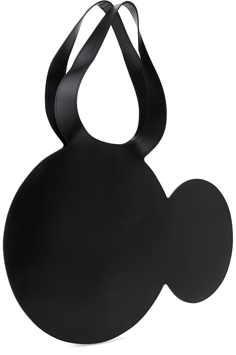 Graphic buffed calfskin tote in black.

· Twin carry handles
· Silver-tone logo stamp at face 
· Open throat
· H13.5" x W19.75"
· Total height: H21"

Part of the Disney capsule.

Supplier color: Black