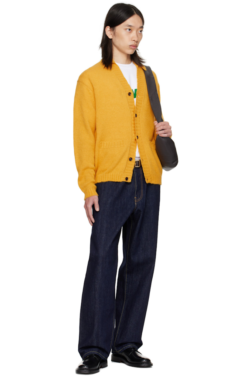 Knit alpaca-blend cardigan.

· Rib-knit spread collar, placket, hem, and cuffs
· Button closure
· Welt pockets at front
· Dropped shoulders

Supplier color: Marigold