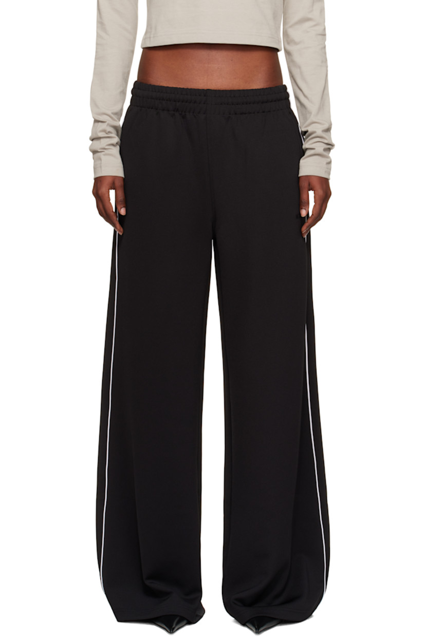 Stretch jersey track pants.

· Flared, wide-leg
· Mid-rise
· Concealed drawstring at elasticized waistband
· Four-pocket styling
· Logo embroidered at front
· Piping at outseams
· Rubberized logo patch at back pocket

Supplier color: Black