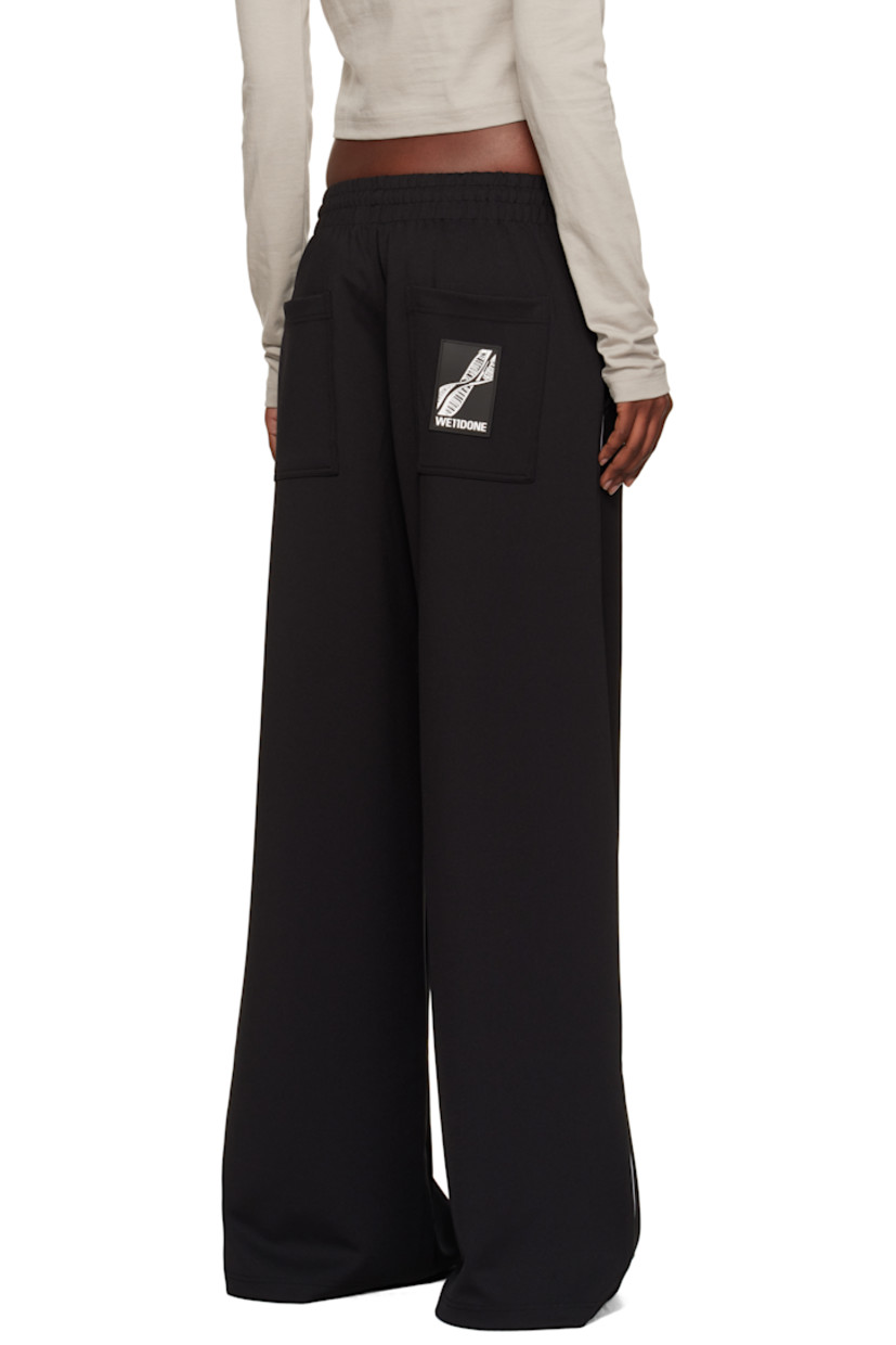 Stretch jersey track pants.

· Flared, wide-leg
· Mid-rise
· Concealed drawstring at elasticized waistband
· Four-pocket styling
· Logo embroidered at front
· Piping at outseams
· Rubberized logo patch at back pocket

Supplier color: Black