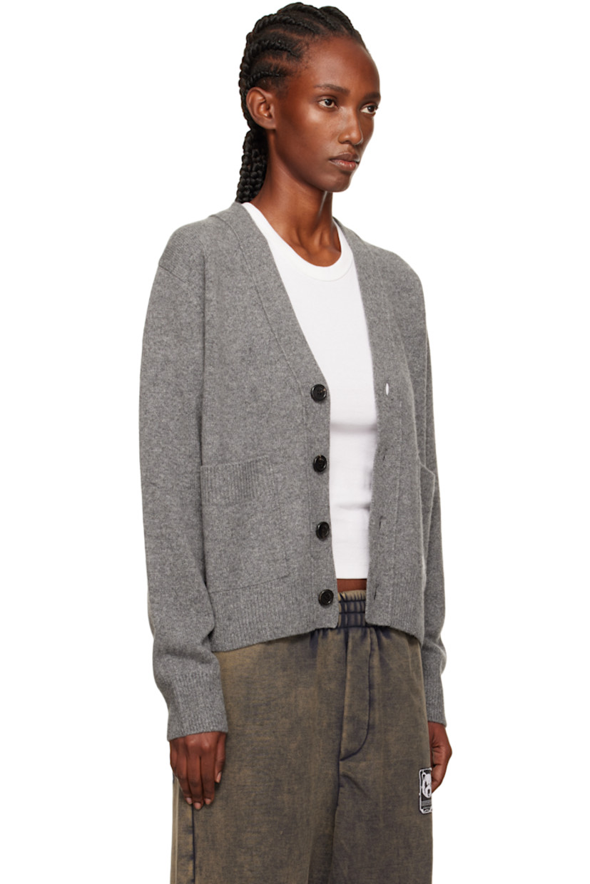 Brushed knit wool-blend cardigan.

· Rib-knit Y-neck, hem, and cuffs
· Button closure
· Patch pockets at waist
· Intarsia logo at pocket

Supplier color: Charcoal