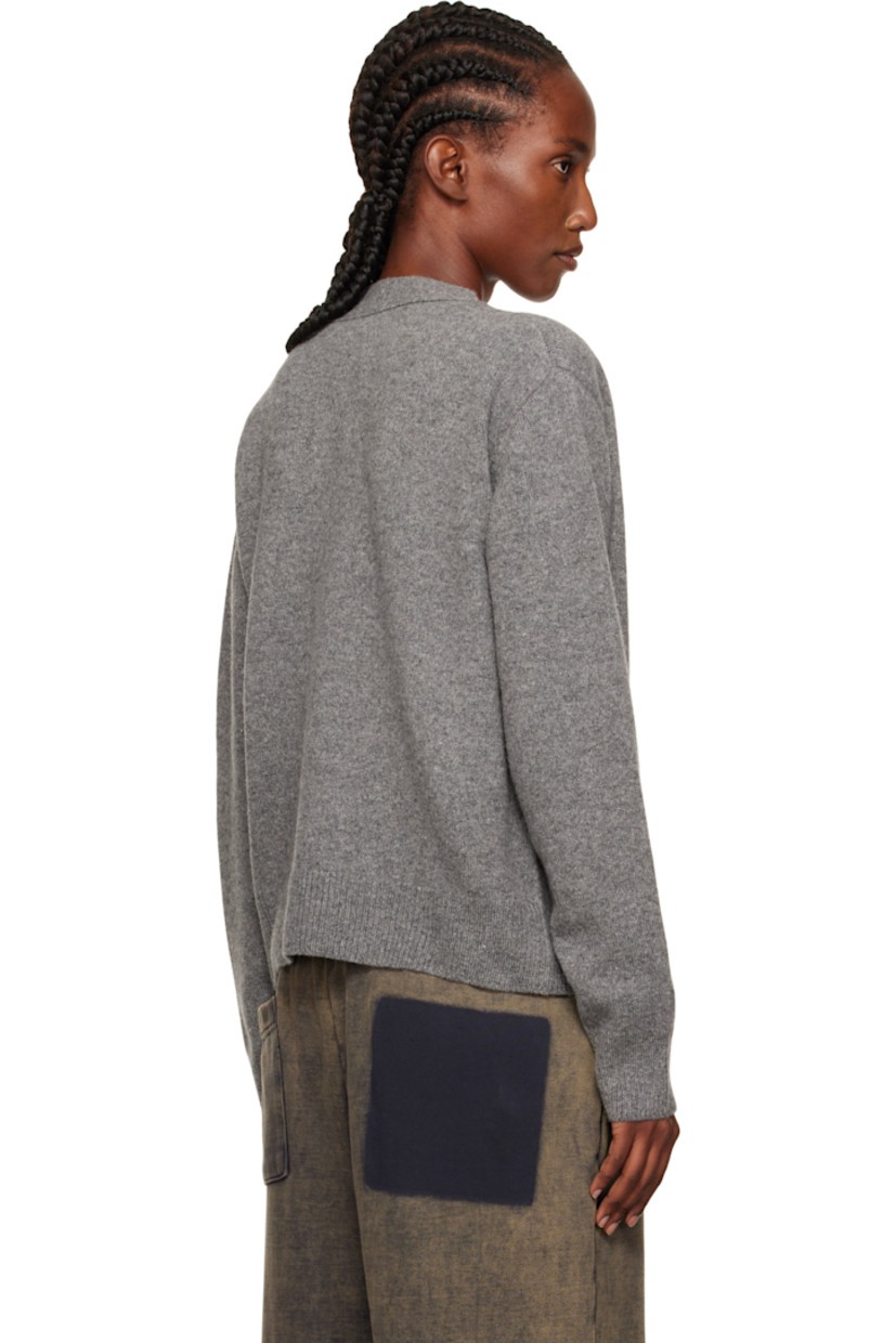 Brushed knit wool-blend cardigan.

· Rib-knit Y-neck, hem, and cuffs
· Button closure
· Patch pockets at waist
· Intarsia logo at pocket

Supplier color: Charcoal