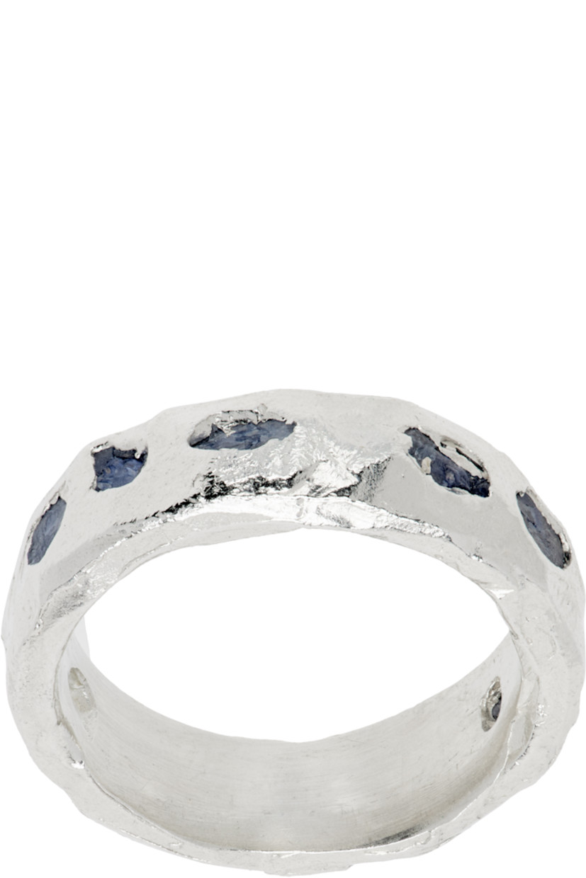 Handcrafted band ring in sterling silver.

· Textured detailing throughout
· Bezel-set 2 cttw sapphires at face
· Full hallmarking 

Supplier color: Silver/Sapphire