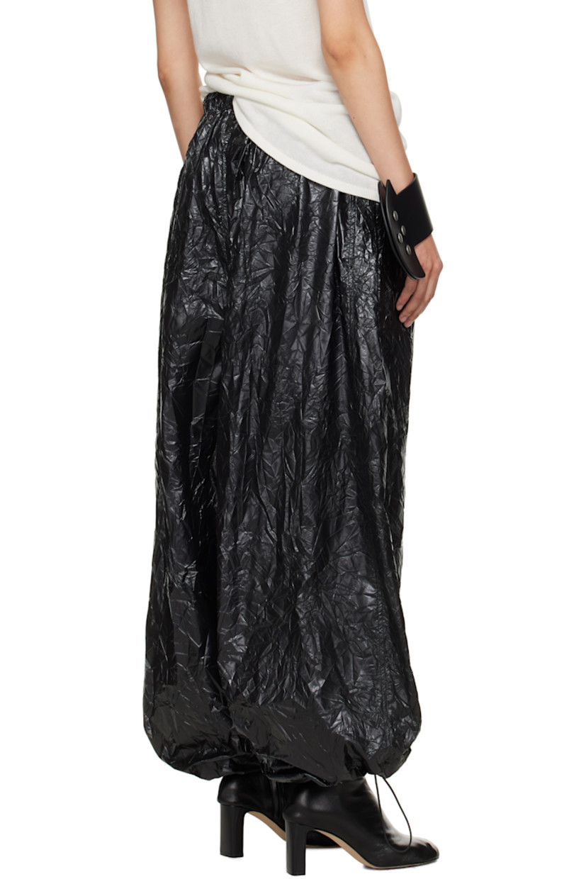 Resin-coated nylon sweatpants.

· Wide-leg 
· Drawstring at elasticized waistband 
· Two-pocket styling
· Button fly  
· Logo patch at front 
· Cord-lock drawstring at cuffs

Supplier color: Black