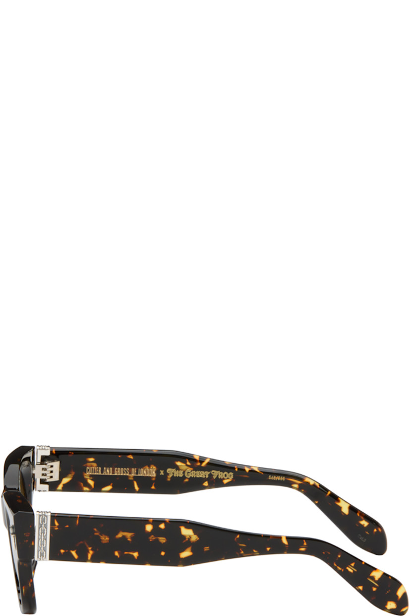 Handcrafted square semi-transparent tortoiseshell acetate-frame sunglasses.

· Gradient gray lenses
· 100% UVA/UVB protection
· Integrated nose pads
· Sterling silver graphic hardware at face and temples
· Core wire at temples
· Includes case
· Size: 51.22 150

Part of the Cutler and Gross x The Great Frog collaboration.

Supplier color: Black on havana