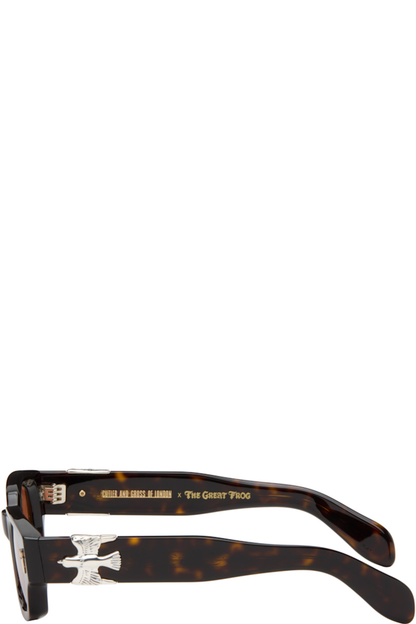 Handcrafted rectangular semi-transparent tortoiseshell acetate-frame sunglasses.

· Orange lenses
· 100% UVA/UVB protection
· Integrated nose pads
· Sterling silver graphic hardware at face and temples
· Exposed core wires
· Includes case
· Size: 50.23 150

Part of the Cutler and Gross x The Great Frog collaboration.

Supplier color: Havana