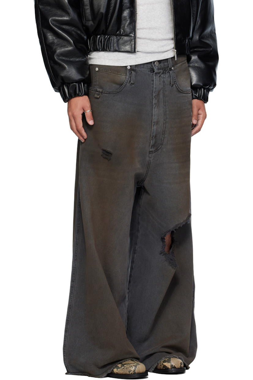 Non-stretch denim jeans.

· Wide-leg 
· Fading, whiskering, smudging, and distressing throughout 
· Belt loops
· Five-pocket styling
· Zip fly 
· Concealed drawstring at waistband 
· Hammer loop at front pocket 
· Raw edge at cuffs
· Logo patch at back waistband
· Logo-engraved silver-tone hardware

Supplier color: Dirty outcast grey