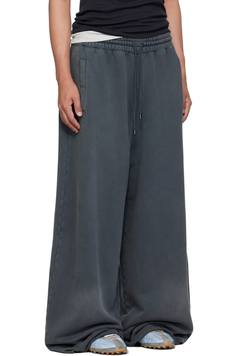 French terry sweatpants.

· Fading throughout 
· Drawstring at elasticized waistband
· Three-pocket styling
· Logo embroidered at front 
· Raw edge at rolled cuffs

Supplier color: Black smoke