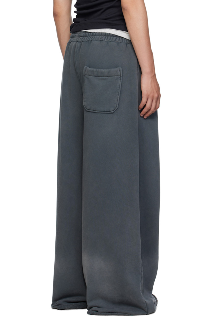 French terry sweatpants.

· Fading throughout 
· Drawstring at elasticized waistband
· Three-pocket styling
· Logo embroidered at front 
· Raw edge at rolled cuffs

Supplier color: Black smoke