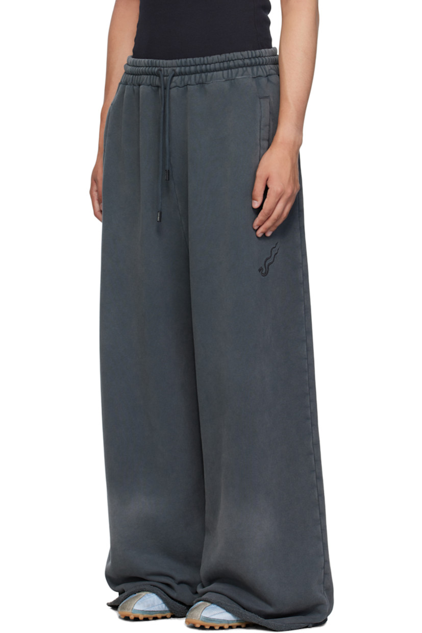 French terry sweatpants.

· Fading throughout 
· Drawstring at elasticized waistband
· Three-pocket styling
· Logo embroidered at front 
· Raw edge at rolled cuffs

Supplier color: Black smoke