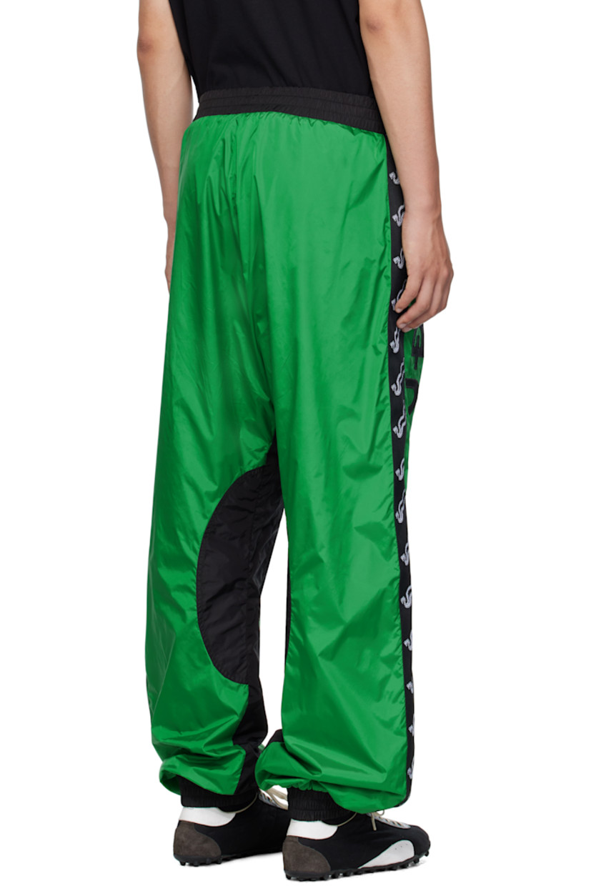 Nylon satin track pants.

· Elasticized waistband and cuffs
· Two-pocket styling
· Logo patch at front 
· Embroidered logo at legs 
· Jacquard logo trim at outseams
· Full mesh lining

Supplier color: Racing green/Black