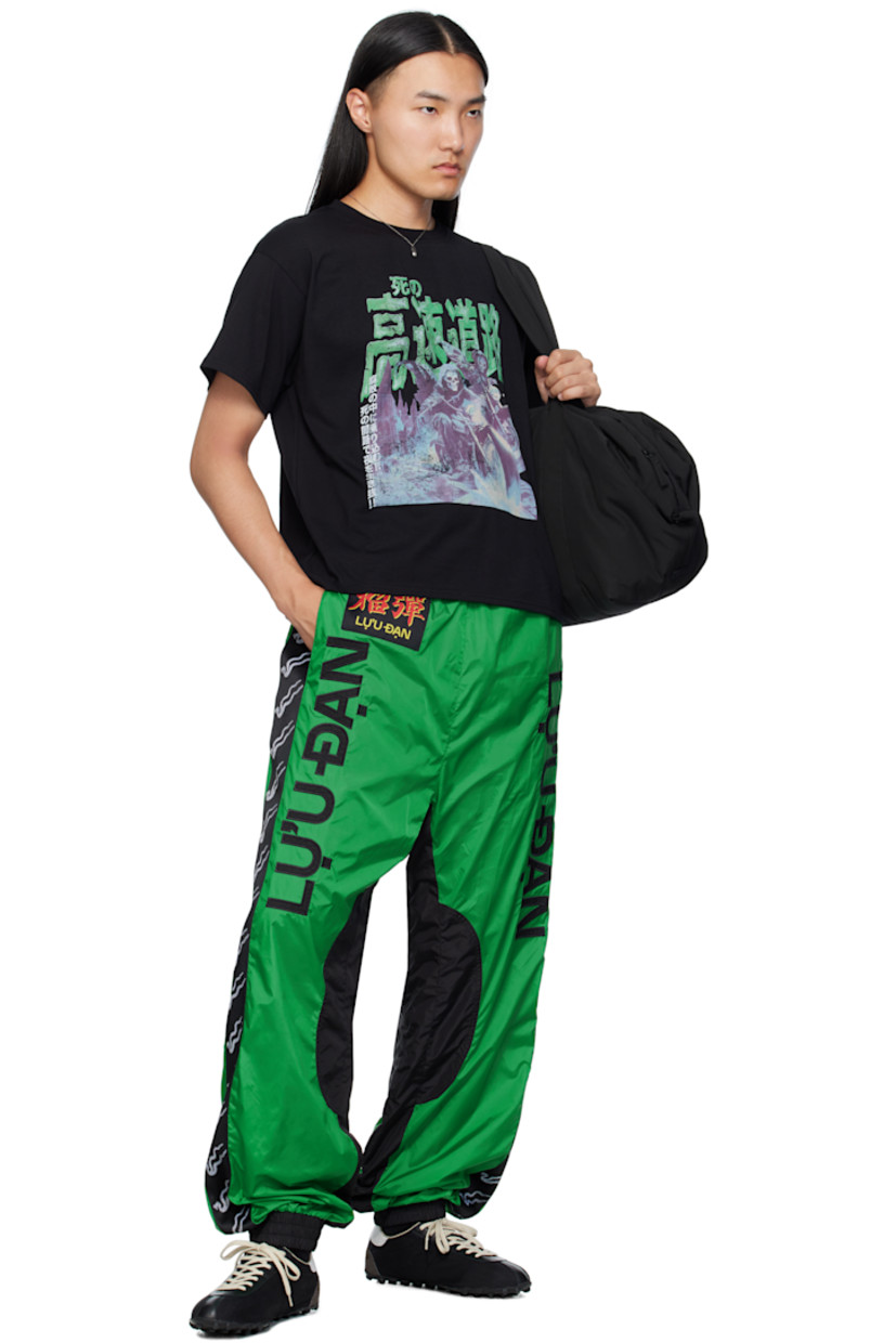 Nylon satin track pants.

· Elasticized waistband and cuffs
· Two-pocket styling
· Logo patch at front 
· Embroidered logo at legs 
· Jacquard logo trim at outseams
· Full mesh lining

Supplier color: Racing green/Black