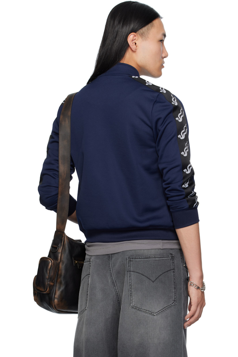 Jersey track jacket. 

· Stand collar 
· Zip closure
· Logo patch at chest
· Embroidered logo appliqués and patch pockets at front 
· Rib-knit hem and cuffs
· Jacquard logo trim at sleeves

Supplier color: Deep navy