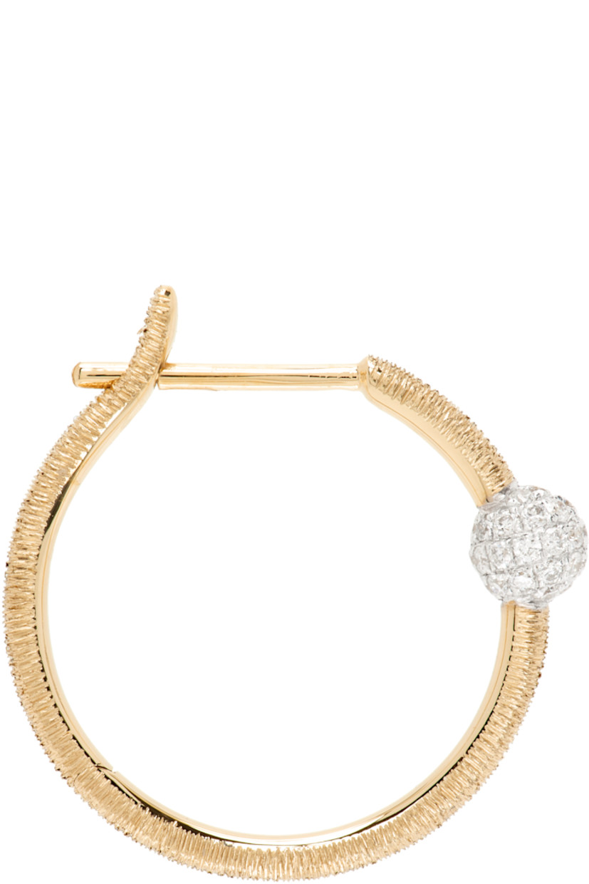 Single hoop earring in 14k gold. 

· Pavé-set 0.14 cttw diamonds 
· Hinged-post fastening 
· D0.75"

Supplier color: 14k yg