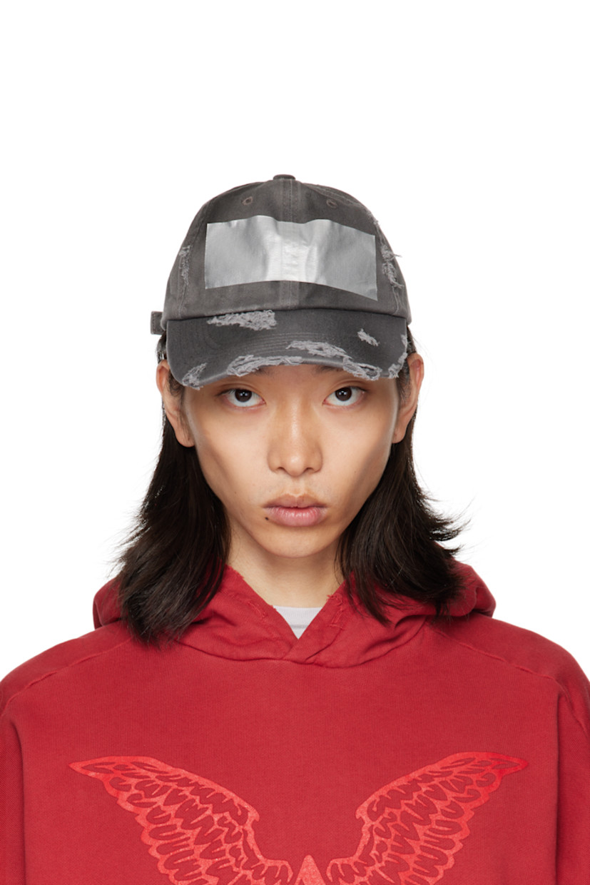 Cotton twill cap. 

· Fading and distressing throughout
· Embroidered eyelets at crown
· Tape accent at face
· Curved brim 
· Cinch fastening 
· Twill browband

Supplier color: Dirty grey