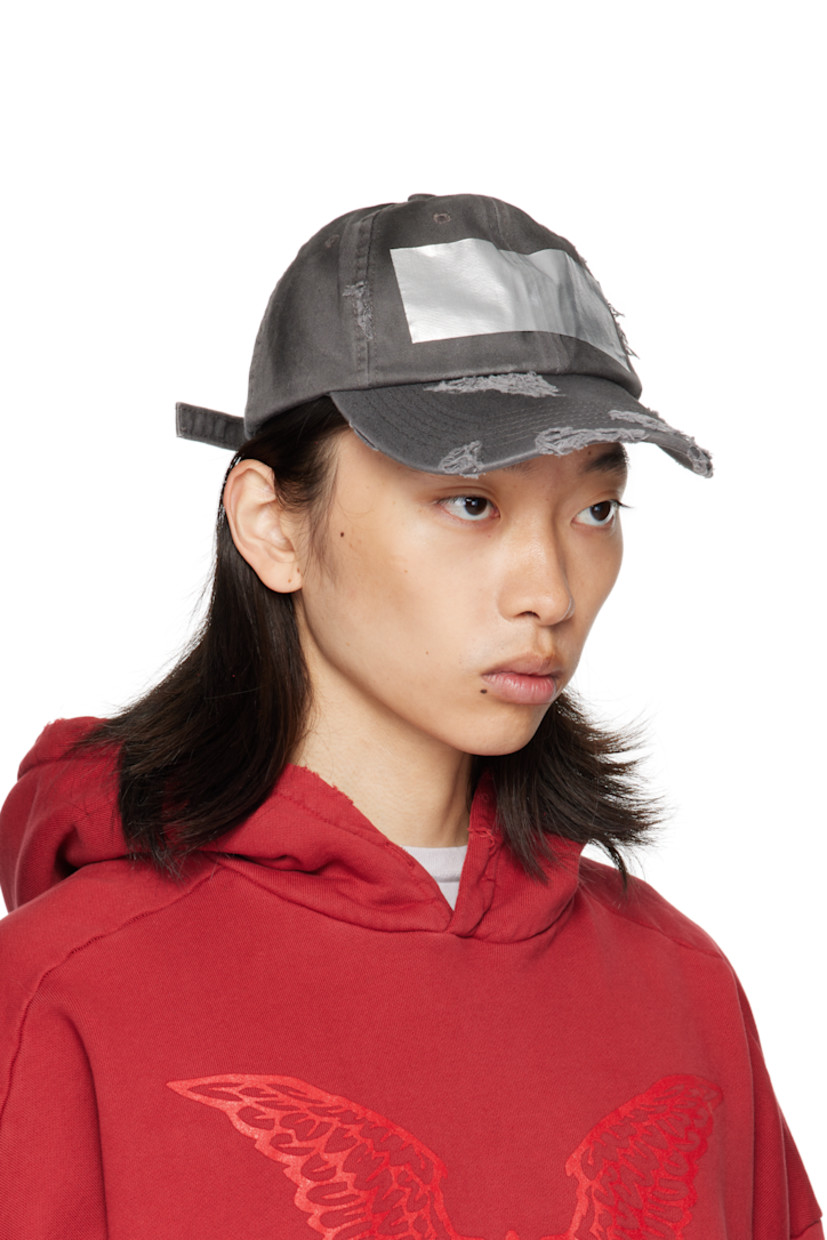 Cotton twill cap. 

· Fading and distressing throughout
· Embroidered eyelets at crown
· Tape accent at face
· Curved brim 
· Cinch fastening 
· Twill browband

Supplier color: Dirty grey