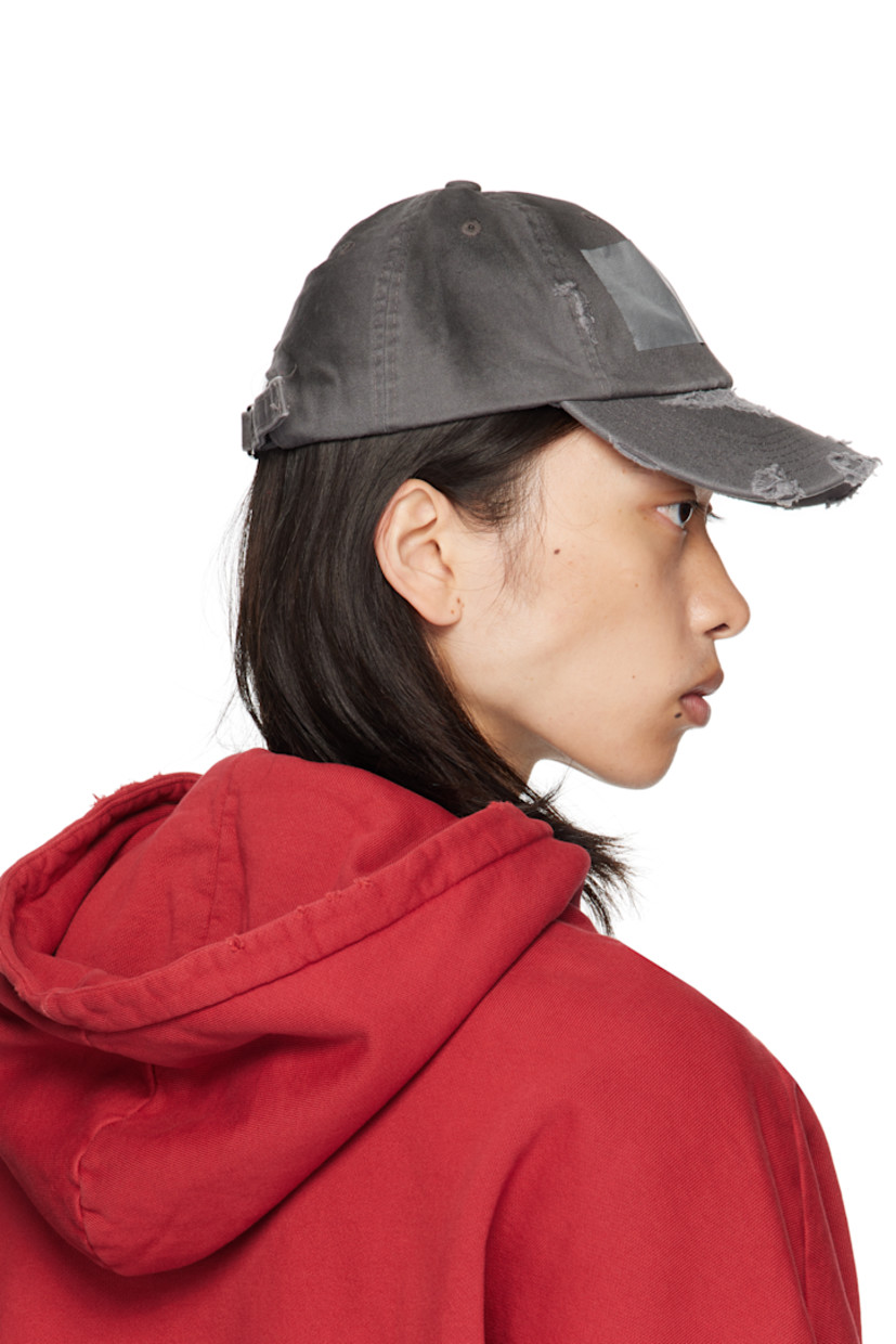 Cotton twill cap. 

· Fading and distressing throughout
· Embroidered eyelets at crown
· Tape accent at face
· Curved brim 
· Cinch fastening 
· Twill browband

Supplier color: Dirty grey