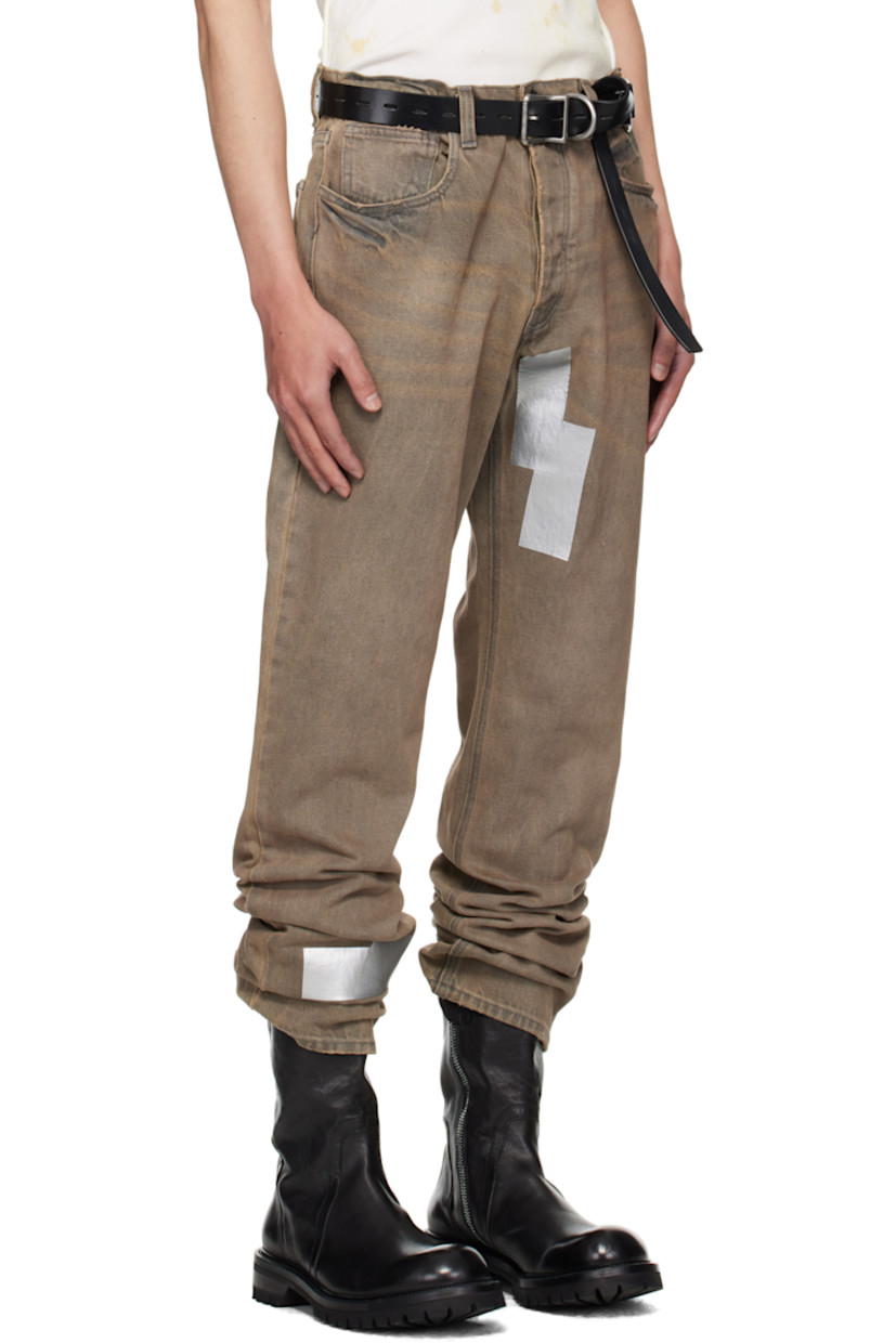 Straight-leg non-stretch denim jeans. 

· Fading, whiskering, distressing, and tape accents throughout 
· Belt loops
· Five-pocket styling
· Button fly 
· Logo patch at back waistband

Supplier color: Washed grey