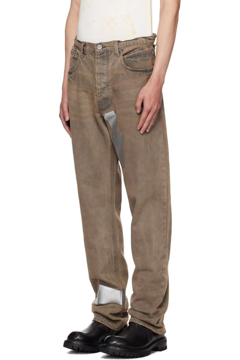 Straight-leg non-stretch denim jeans. 

· Fading, whiskering, distressing, and tape accents throughout 
· Belt loops
· Five-pocket styling
· Button fly 
· Logo patch at back waistband

Supplier color: Washed grey
