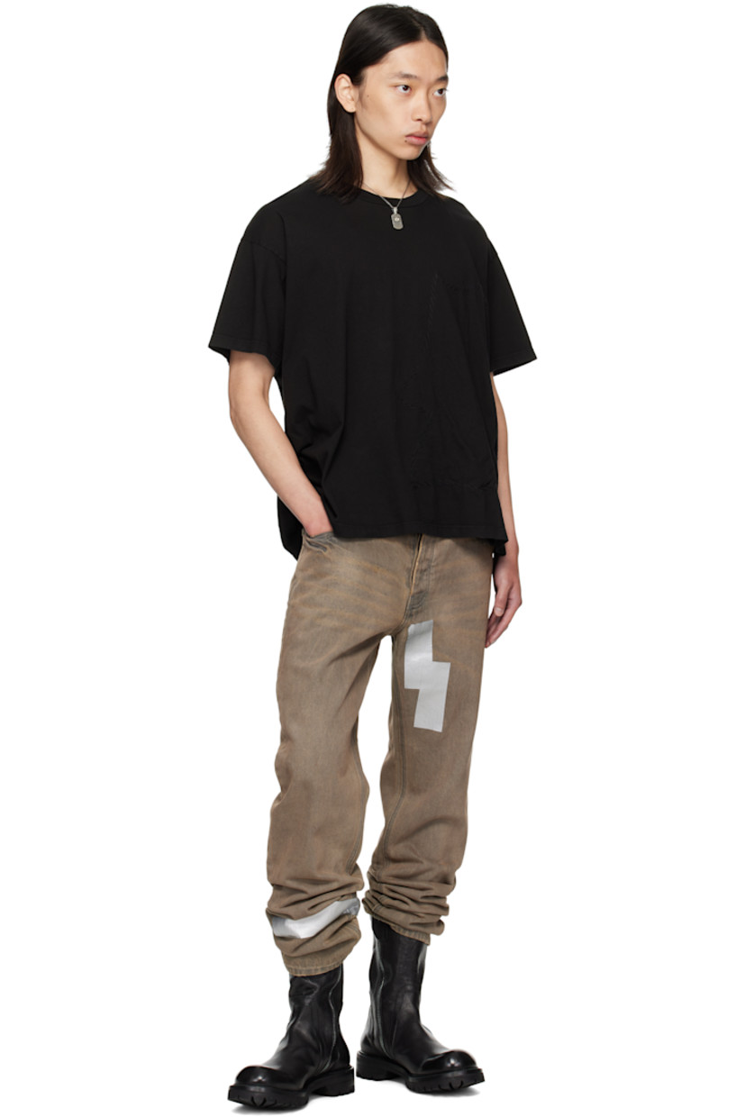 Cotton jersey T-shirt. 

· Exposed seams throughout 
· Rib-knit crewneck
· Jersey appliqué with rolled edges at front 
· Dropped shoulders

Supplier color: Black