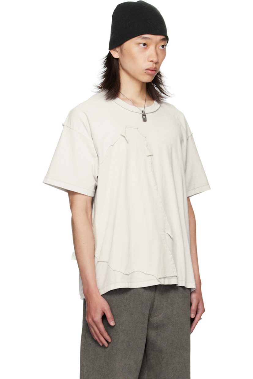 Cotton jersey T-shirt. 

· Exposed seams throughout 
· Rib-knit crewneck
· Jersey appliqué with rolled edges at front 
· Dropped shoulders

Supplier color: Light oil