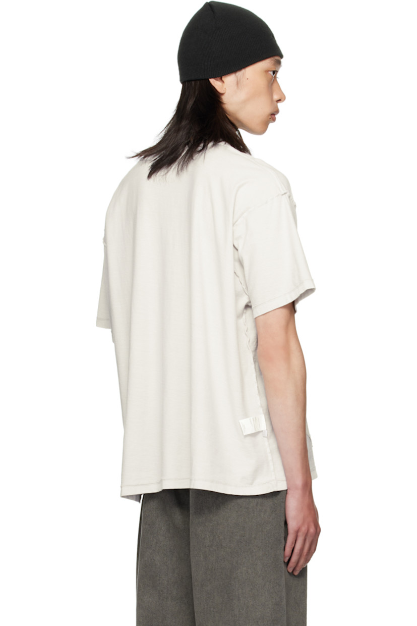 Cotton jersey T-shirt. 

· Exposed seams throughout 
· Rib-knit crewneck
· Jersey appliqué with rolled edges at front 
· Dropped shoulders

Supplier color: Light oil