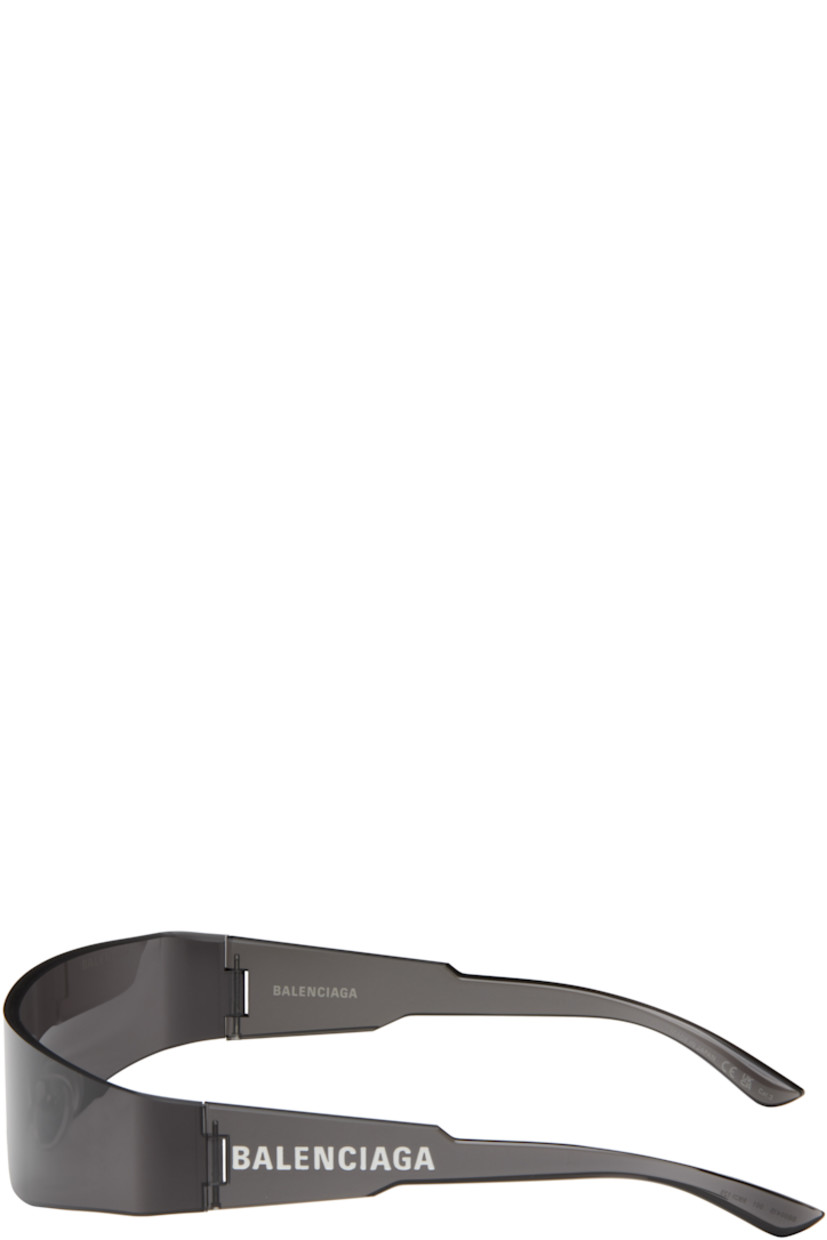 Wraparound rimless acetate-frame sunglasses in black. 

· Gray lens
· 100% UVA/UVB protection, category 1 
· Adjustable rubber nose pads
· Logo printed at temple 
· Includes case
· Size: 125

Supplier color: Grey/Grey/Grey