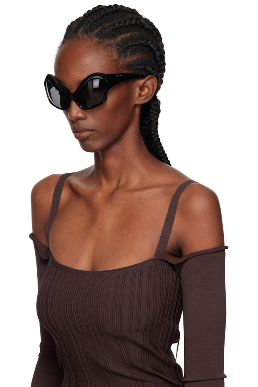Modified cat-eye acetate-frame sunglasses.

· Integrated nose pads
· Black lenses with 100% UVA/UVB protection
· Logo etched at temples
· Hardware at temple tips
· Titanium hardware
· Logo-embossed squeeze-top pouch
· Size: 58.20 120

Supplier color: Black