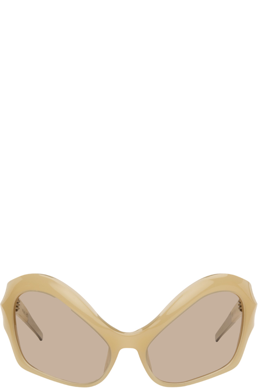 Modified cat-eye acetate-frame sunglasses.

· Integrated nose pads
· Brown lenses with 100% UVA/UVB protection
· Logo etched at temples
· Hardware at temple tips
· Titanium hardware
· Logo-embossed squeeze-top pouch
· Size: 58.20 120

Supplier color: Beige
