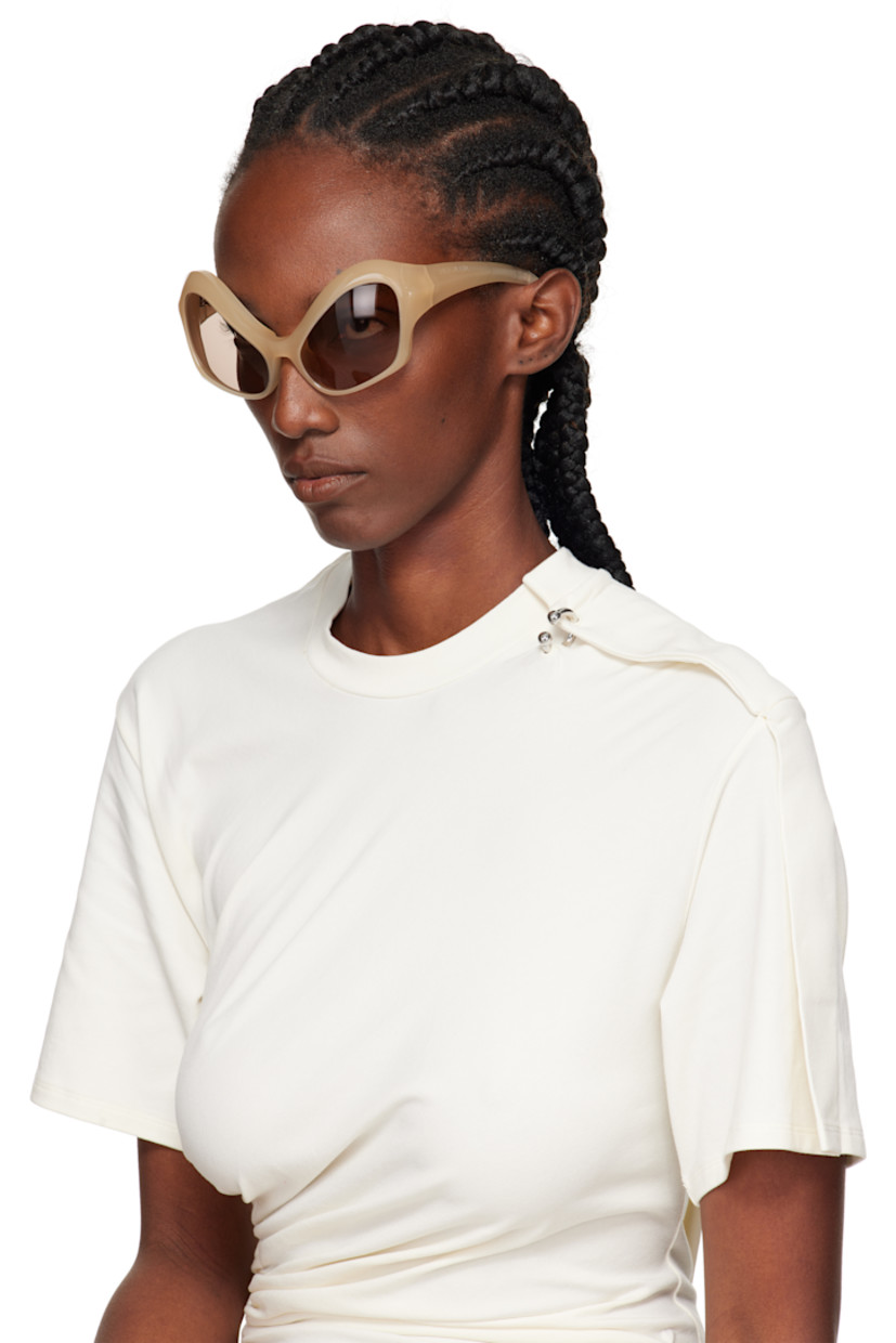 Modified cat-eye acetate-frame sunglasses.

· Integrated nose pads
· Brown lenses with 100% UVA/UVB protection
· Logo etched at temples
· Hardware at temple tips
· Titanium hardware
· Logo-embossed squeeze-top pouch
· Size: 58.20 120

Supplier color: Beige